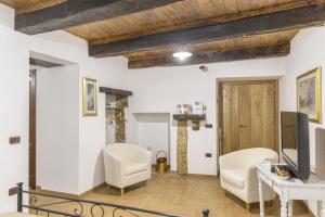 a living room with white walls and wooden ceilings at Modern Apartment near Arce City Centre, 62 m², Parking in Arce +24 photos