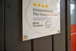a sign on the door of a tiny house consulate at Tiny House Gerswalde in Gerswalde +23 photos