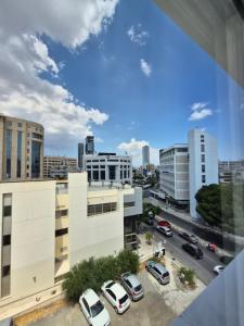 a view of a city with cars parked in a parking lot at J Aurora in Nicosia