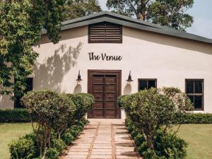 a white building with the vine sign on it at Kearsney Manor in KwaDukuza