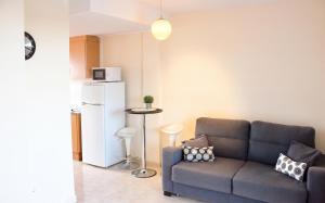 a living room with a couch and a refrigerator at Cozy apartment in Dénia, 40 m² with shared pool in Denia