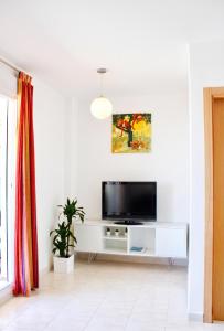 a living room with a tv on a white entertainment center at Cozy apartment in Dénia, 40 m² with shared pool in Denia