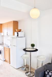 a kitchen with a table and a white refrigerator at Cozy apartment in Dénia, 40 m² with shared pool in Denia +13 photos