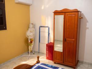 a room with a mirror and a wooden cabinet at Appartement spacieux à Petit Canal - 65 m² - Vue sur jardin in Petit-Canal