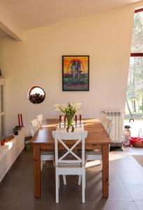 a dining room with a wooden table and white chairs at Spacious House in Seia with Stunning Mountain Views, 150 m² in Seia +22 photos