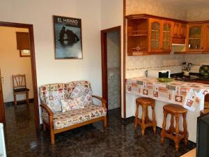 a kitchen with a couch and a chair and a counter at Cozy apartment with sea view in Frontera in Frontera +15 photos
