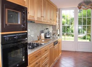 a kitchen with a sink and a stove top oven at Charming villa with mountain view in Pedraça, pool in Pedraça