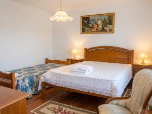 a bedroom with two beds and a painting on the wall at Charming villa with mountain view in Pedraça, pool in Pedraça +17 photos