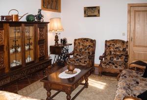 a living room with two chairs and a coffee table at Charming villa with mountain view in Pedraça, pool in Pedraça