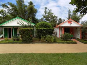 a couple of houses with bushes and trees at Charming house with sea view in Foulpointe + Enclosed garden. in Foulpointe