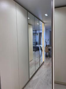a hallway with mirrors and a living room at Millennium Apart Complex in Sveti Vlas