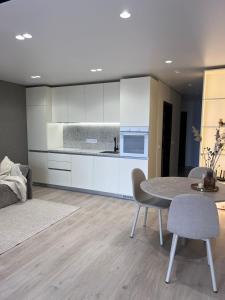 a living room with a table and a kitchen at Millennium Apart Complex in Sveti Vlas