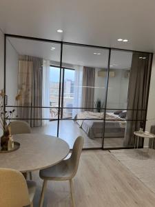 a bedroom with a bed and a table and chairs at Millennium Apart Complex in Sveti Vlas
