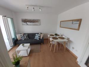 a living room with a couch and a table at Charming apartment with mountain view in Francàs - 45m² in Comarruga