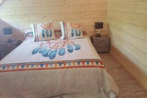 a bedroom with a bed and a wooden wall at Villa spacieuse avec piscine à Aspin-en-Lavedan, vue montagne. in Aspin-en-Lavedan