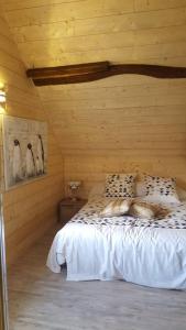 a bedroom with a bed in a wooden room at Villa spacieuse avec piscine à Aspin-en-Lavedan, vue montagne. in Aspin-en-Lavedan
