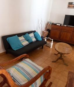 a living room with a couch and a table at Maison charmante vue sur mer à La Trinité, 2 chambres. in La Trinité