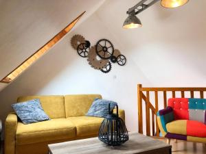 a living room with a couch and a chair at Appartement charmant à Sarzeau avec vue sur la mer, 55 m² in Sarzeau