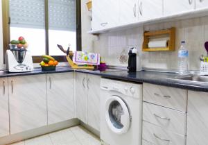 a kitchen with a washing machine in a kitchen at Comfortable Apartment in Almuñécar in Almuñécar