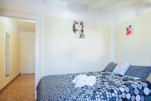 a bedroom with a bed with a blue and white comforter at Charming House in Costa Calma with Mountain View and Terrace in Costa Calma +29 photos