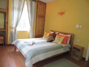 a bedroom with a bed with colorful pillows and a window at Charming villa in Blue Bay with private pool in Blue Bay