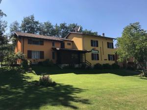 a large house with a large yard in front of it at Comfortable Chalet in Giarola with Mountain View in Busana +35 photos