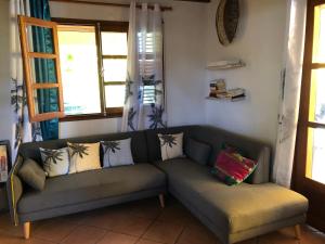 a living room with a couch and two windows at Appartement spacieux à Saint-François 150 m² avec piscine partagée ! in Saint-François