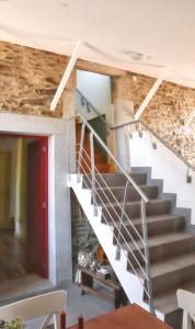 a staircase in a house with a stone wall at Cozy House in Seia with Fireplace in Faia