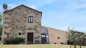 an old stone building with a window and a door at Cozy House in Seia with Fireplace in Faia +22 photos