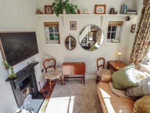 a living room with a couch and a tv at Hangmans cottage in Horncastle