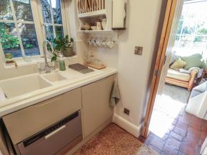a kitchen with a sink and a window at Hangmans cottage in Horncastle +27 photos