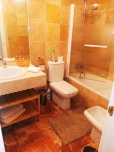 a bathroom with a toilet and a sink and a tub at Spacious apartment in La Cala de Mijas with sea view. in La Cala de Mijas