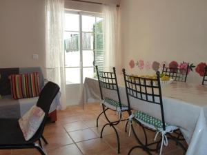 a dining room with a table and four chairs at Charming house in Vila Nova de Cacela with garden in Vila Nova De Cacela