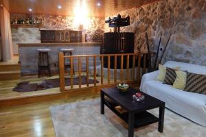 a living room with a couch and a fireplace at Paradisiacal Villa in Lousada with Private Pool in Lousada