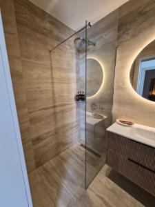a bathroom with a glass shower and a sink at J Aurora in Nicosia +44 photos