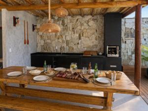 a wooden table with food on it in a kitchen at Vista do Luar Corumbau in Prado
