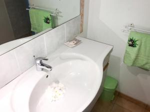 a bathroom with a white sink and a mirror at Studio chaleureux à Sainte-Anne - 29m² avec jardin. in Sainte-Anne