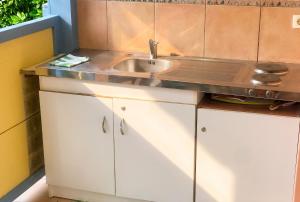 a kitchen with a sink and a counter top at Studio chaleureux à Sainte-Anne - 29m² avec jardin. in Sainte-Anne