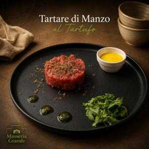 a plate of food with a piece of meat and vegetables at Masseria Grande Hotel - Ristorante in Montecilfone