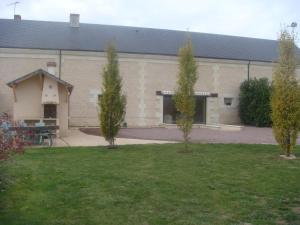 two trees in a yard in front of a building at Maison charmante en campagne à Mouterre-Silly, Jardin, Terrasse. in Mouterre-Silly