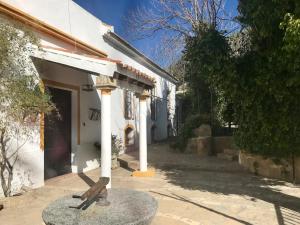 a statue in front of a white building at Elegant Villa in El Saucejo with Private Pool in Saucejo