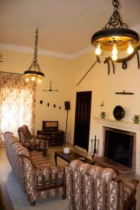 a living room with couches and a fireplace at Elegant Villa in El Saucejo with Private Pool in Saucejo +21 photos