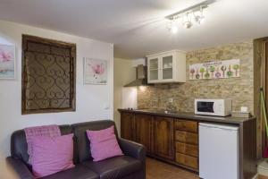 a living room with a couch and a kitchen at Charming villa in Cividade, 150 m² with private pool in Cividade