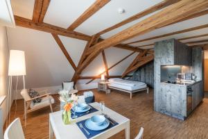 a living room with a white table and chairs at Kloster Kappel in Kappel am Albis