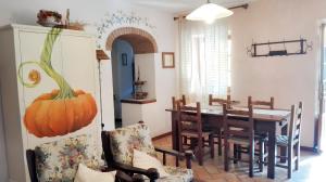a dining room with a table and a pumpkin on the wall at Spacious Apartment in Lisciano Niccone with Mountain View in Mercatale