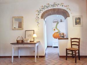 a room with a table and a pumpkin on the wall at Spacious Apartment in Lisciano Niccone with Mountain View in Mercatale