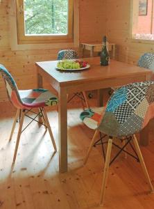 a wooden table and chairs with a plate of grapes on it at Cozy Chalet in Castell'Arquato 90 m² with Private Pool in CastellʼArquato