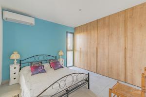 a bedroom with a bed and a wooden wall at Appartement charmant, Malaucène, 52 m², piscine partagée in Malaucène