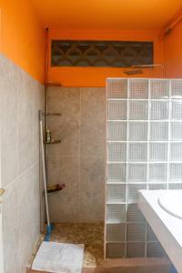 a shower with glass doors and a sink in a bathroom at Charmant studio avec vue sur mer au Moule, 20 m² + terrasse in Le Moule