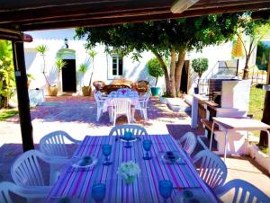 a purple table and white chairs and a table and chairsearcher at Elegant villa with sea view in Loulé + private pool in Loulé